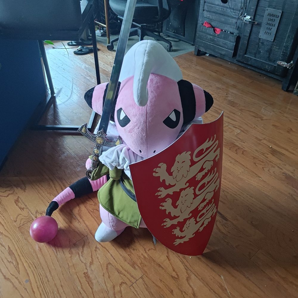 A life sized plush replica of a Flaaffy OC named Derek wielding a prop sword and metal heater shield.