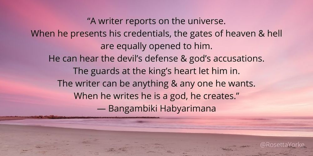 A pink dawn sky over a sandy beach at low tide.  