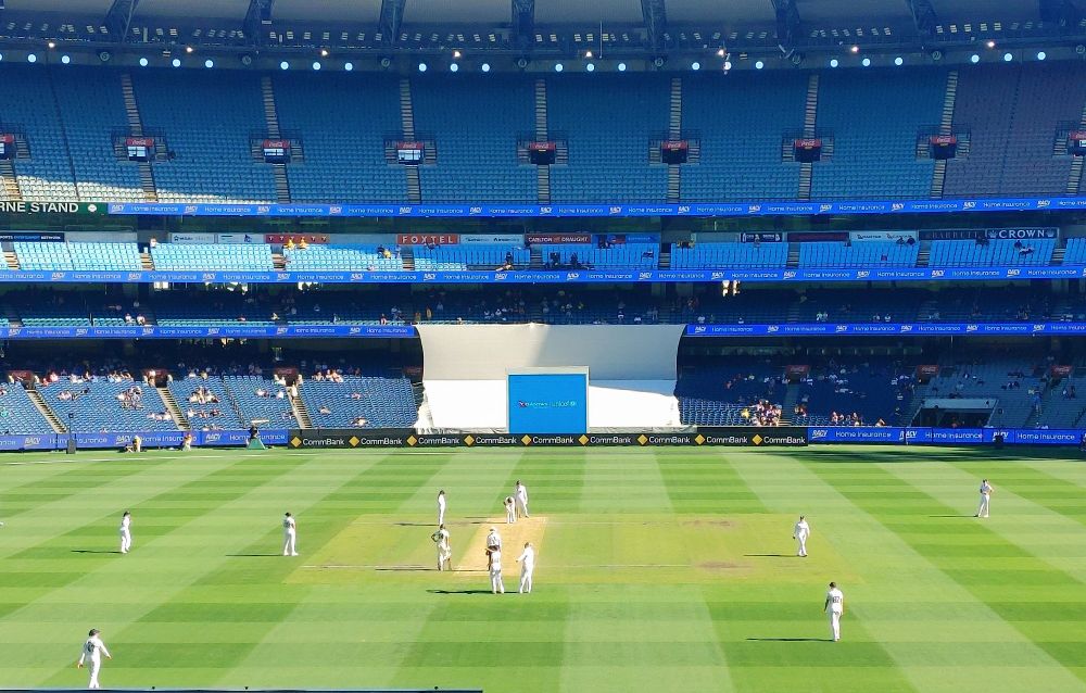 The green grass of the Melbourne Cricket Ground with cricketers in position!