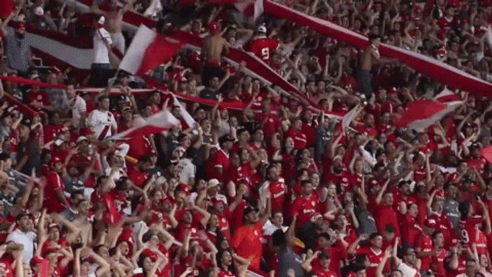 a crowd of people wearing red jerseys with the number 5