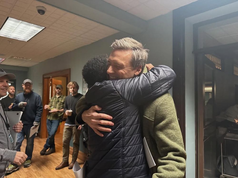 Charles Randolph-Wright hugs Teddy Sears.