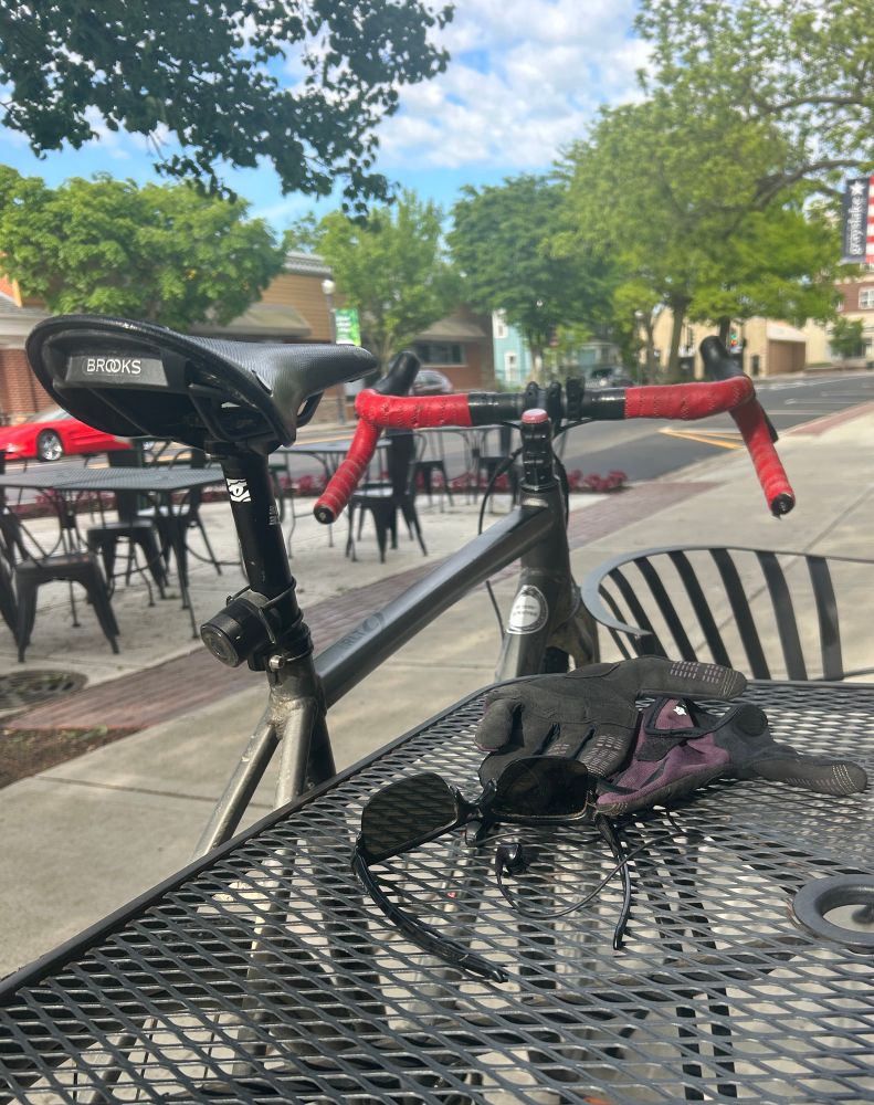 Pic of my bike leaning on a cafe table
