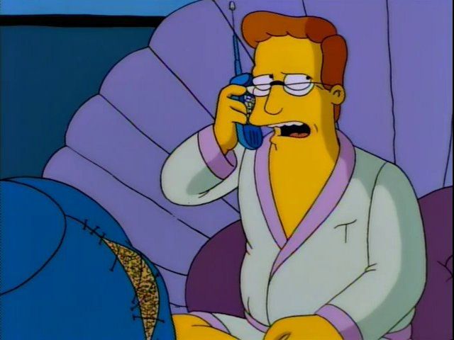 Troy McClure, of The Simpsons. He’s in a seafoam-green robe with purple trim, sitting in a bed shaped like a clamshell, and he’s on the phone with Macarthur Parker, the agent.