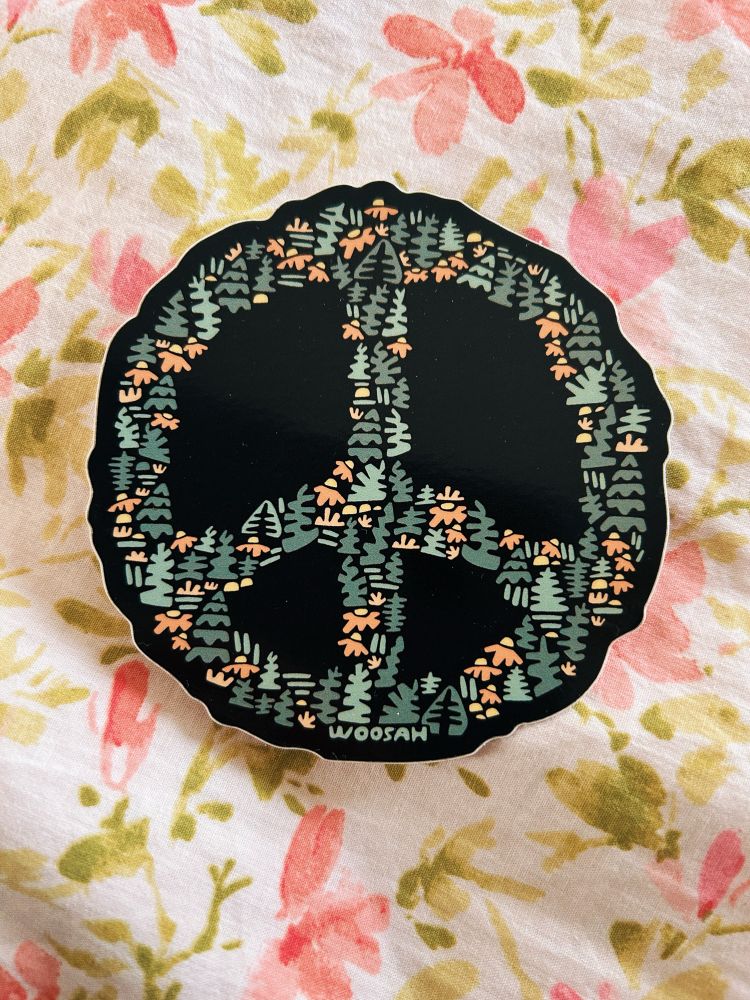 a sticker on floral bedding: a peace sign made of tiny flowers and trees