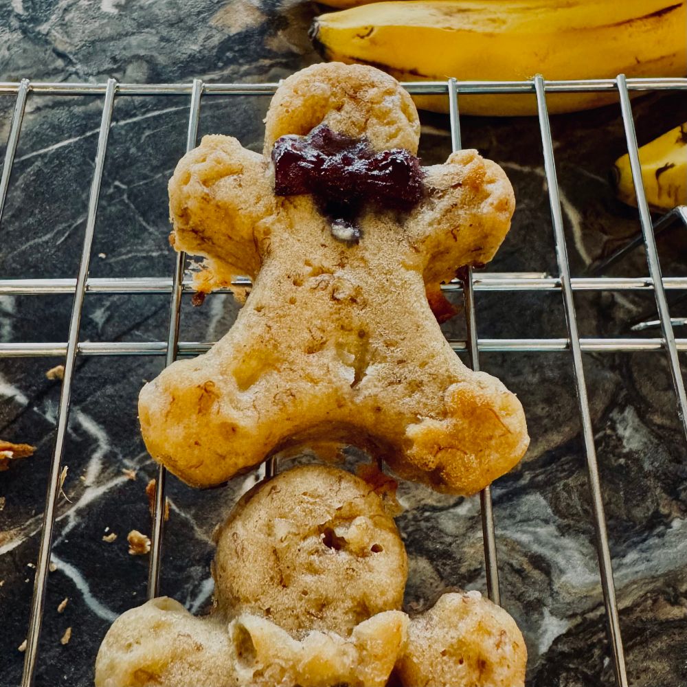 Banana bread muffins in the shape of gingerbread men - blueberry exploded behind one of their bow ties. 