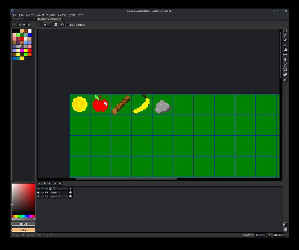 Screenshot from aseprite showing yellow coin, red apple, brown log, yellow banana, gray stone on a green background canvas