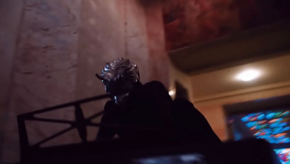 A screenshot from Ghost’s “Rats” video showing the ghoul character playing a piano with his leg up
on the keyboard 