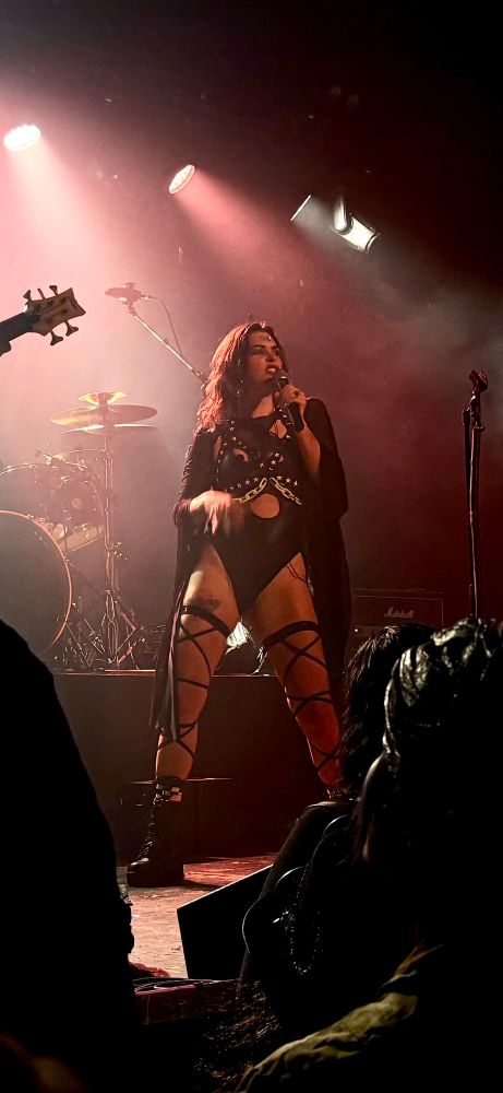 Singer of the band OmenBringer singing on stage