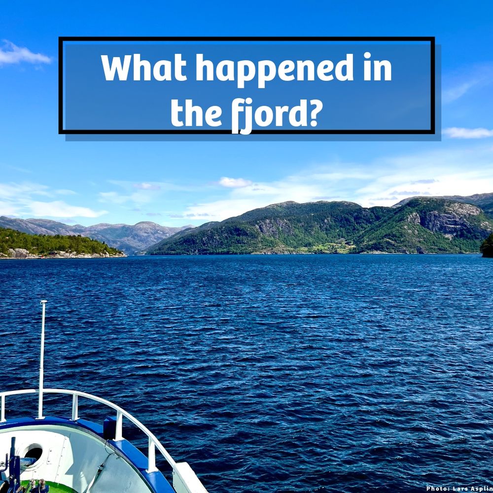 A photo of Masfjorden in Norway which shows blue water and mountains in the distance, and the tip of a research vessel in front. At the top of the image is the text - what happened in the fjord?
