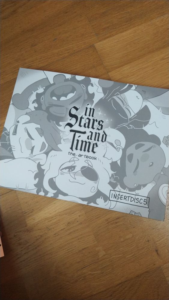 Photo of the "In Stars and Time" artbook.
