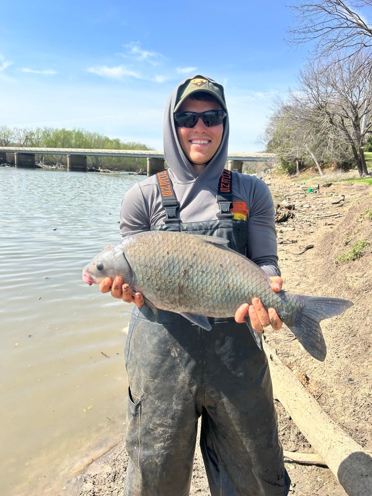 Caleb poses with a deeply-bodied smallmouth buffalo on the shore of the Neosho River in Oklahoma. 