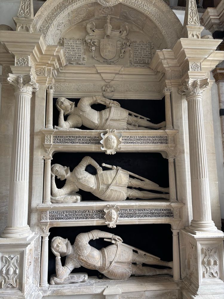Three tiered funerary monument showing reclining figures in Tudor era armour, commemorating members of the Fettiplace family, in St Mary’s church, Swinbrook, UK