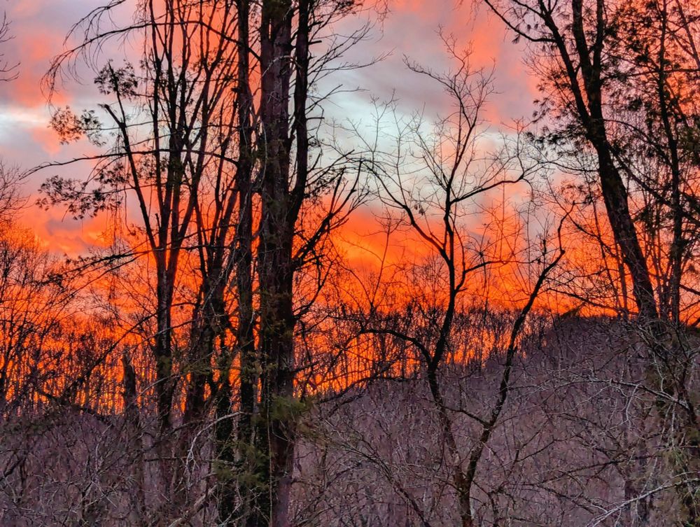 Red, orange, and purple clouds during a mountain sunrise