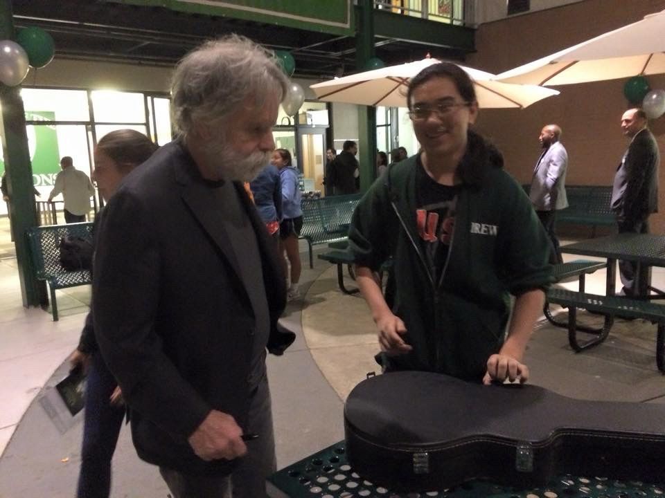 Bob Weir and a 17 year old Nick Jong, as Bob prepares to sign Nick’s guitar