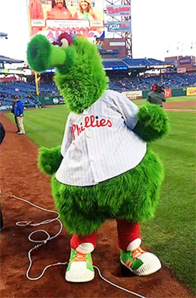 a phillies mascot is standing on the field