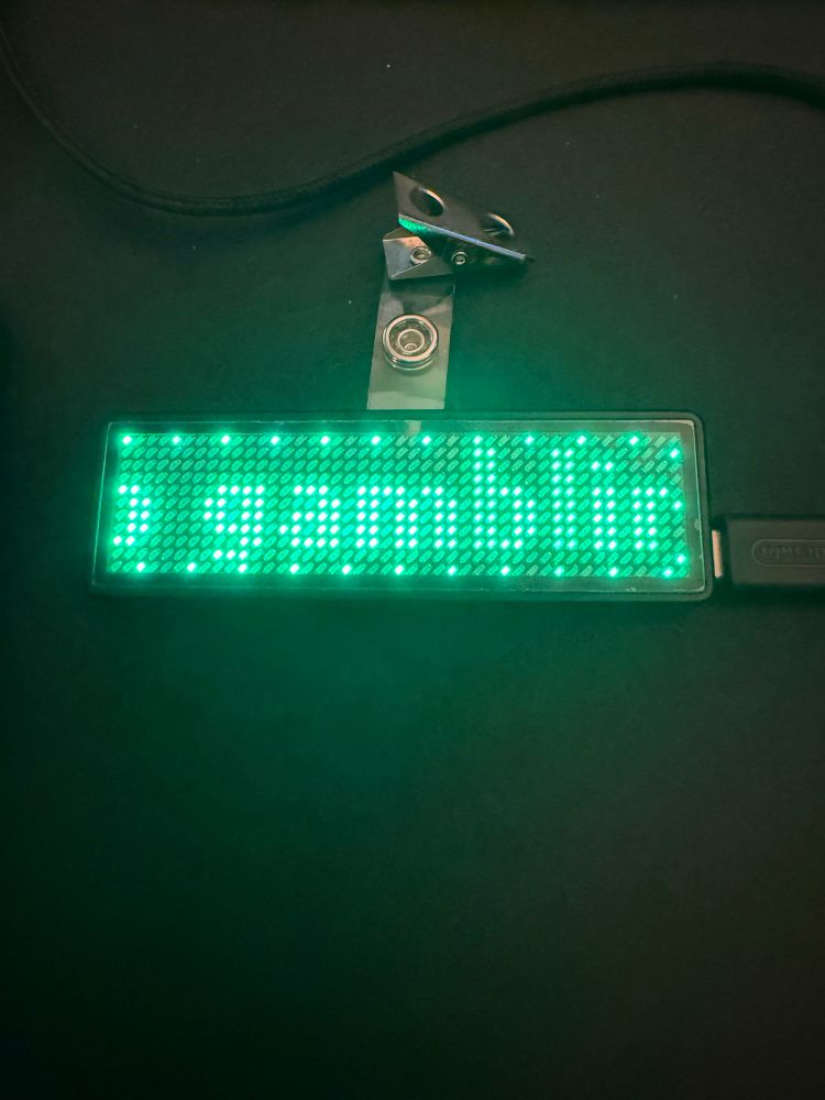 A green LED name badge that says “…o gamblin…”