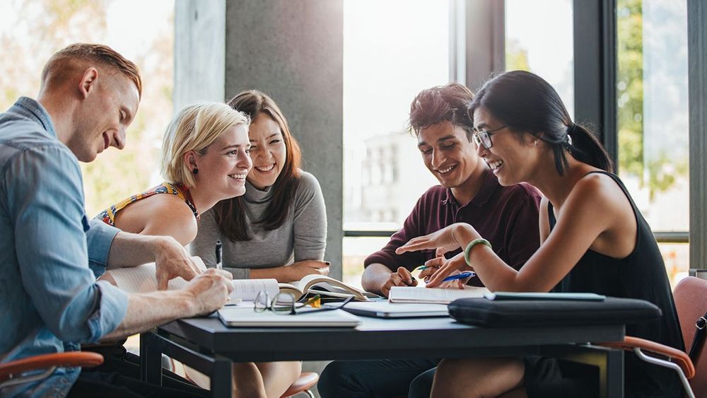 People sat around a table working together.