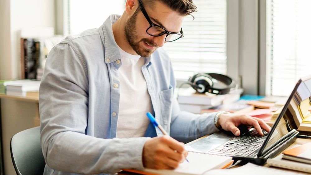 A person doing an online training course on a laptop.