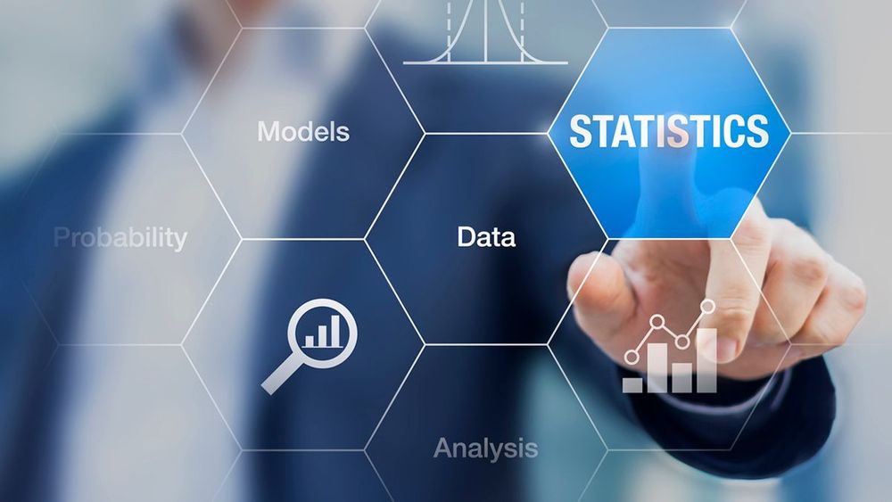 A person pressing a button on a touch screen with the word "Statistics" on it.