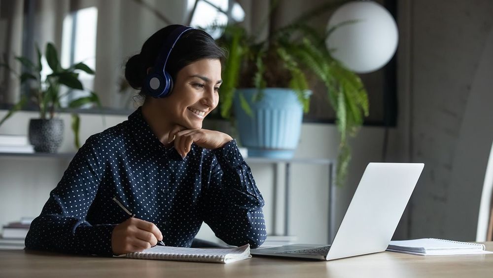 A person doing an online training course on a laptop.