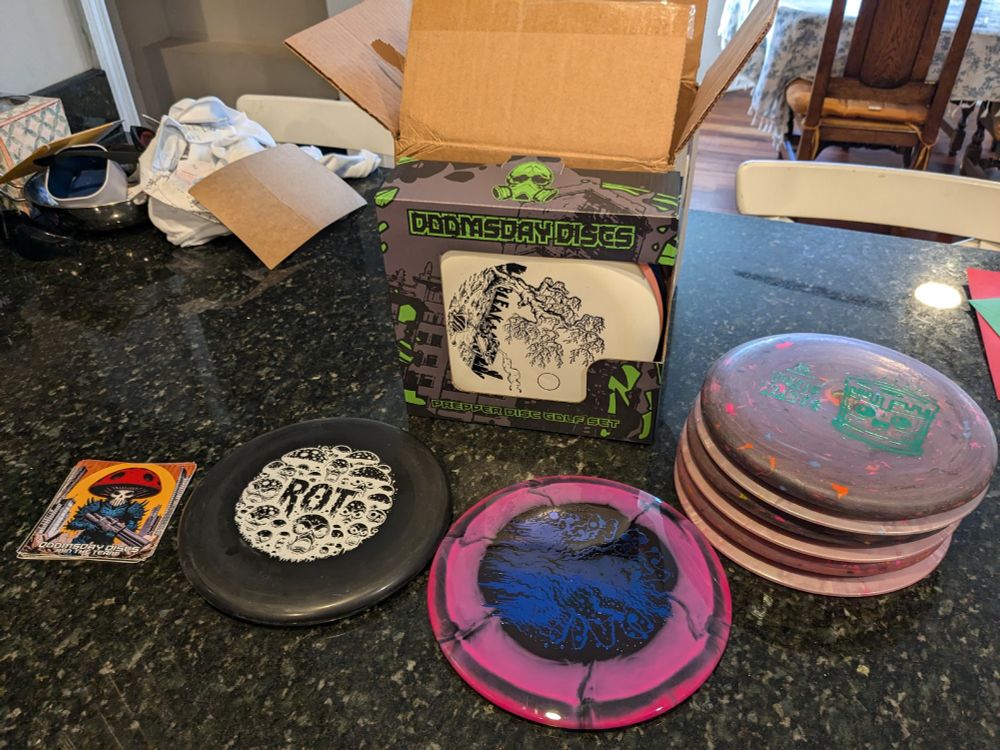 A disc golf disc care package from Doomsday Discs.