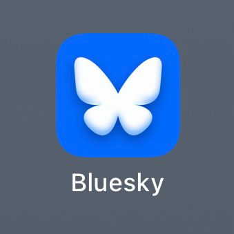extreme closeup of the new Bluesky icon on iOS. instead of being a nice, clean, flat icon they’ve added really gaudy gradient shading & shadowing & I fucking hate it.