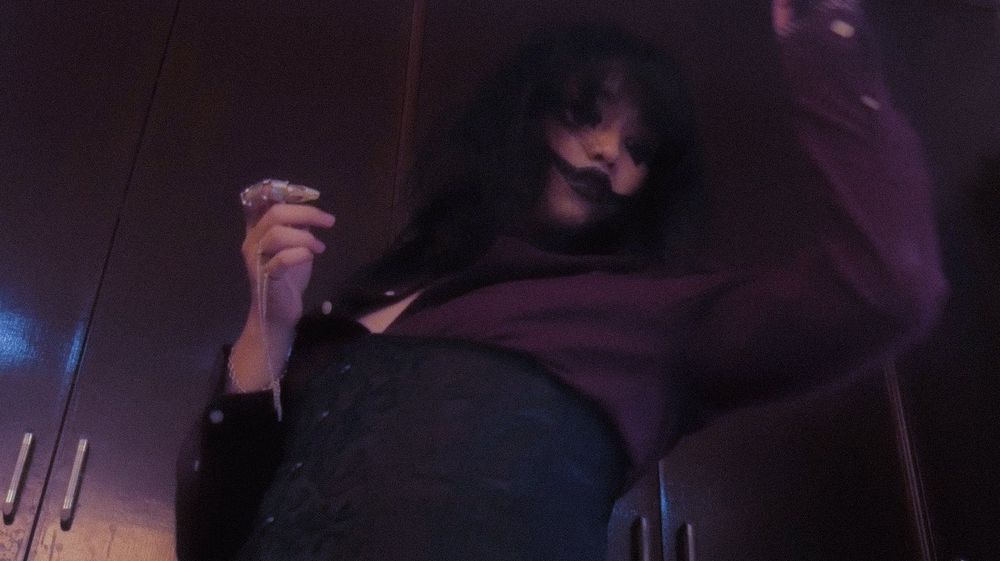 lith mori in goth clown makeup, dressed like a vampire and goth dancing