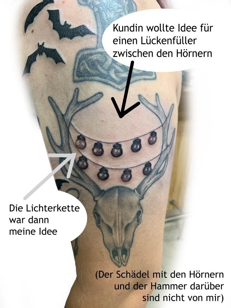 Foto eines Tattoos - Tierschädel mit Hörnern. Zwischen den Hörnern ist eine Lichterkette gespannt.