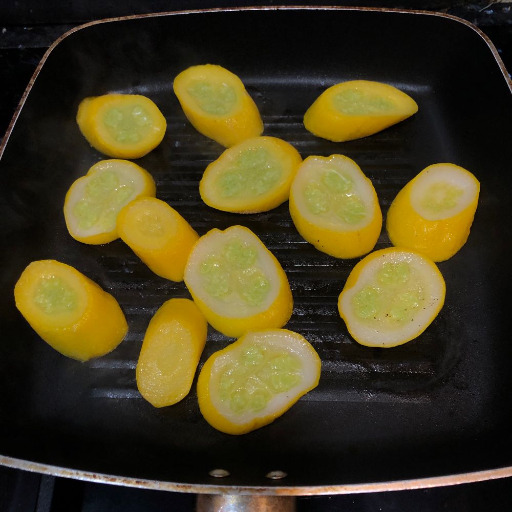 Yellow courgettes on a black griddle pan