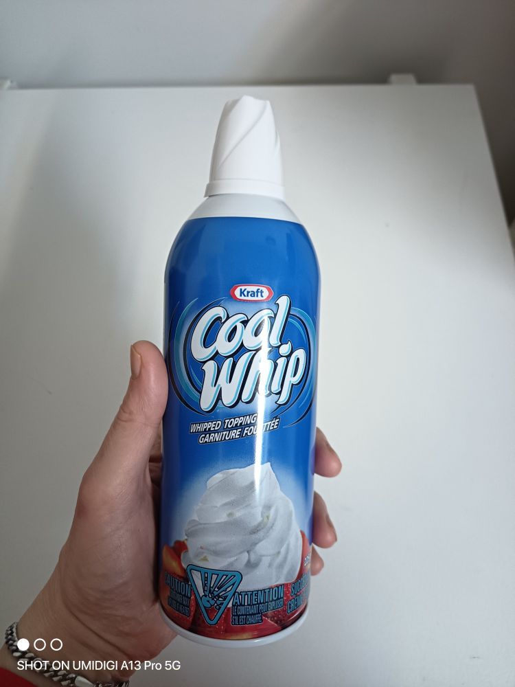 My left hand is holding a can of whipped cream, Kraft cool whip 