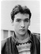 A black and white photograph of a young John Cusack staring with a vaguely penetrating blankness