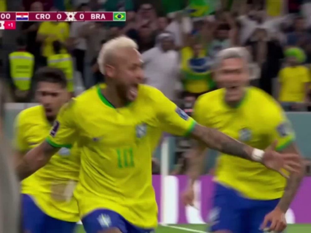 a group of soccer players are celebrating a goal with a scoreboard in the background that says cro 0 bra 1