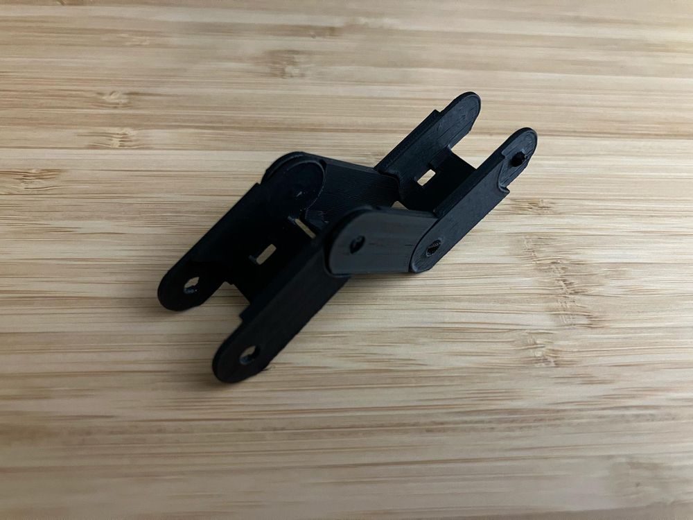 Photo of three chain links connected to each other in a zig zag.