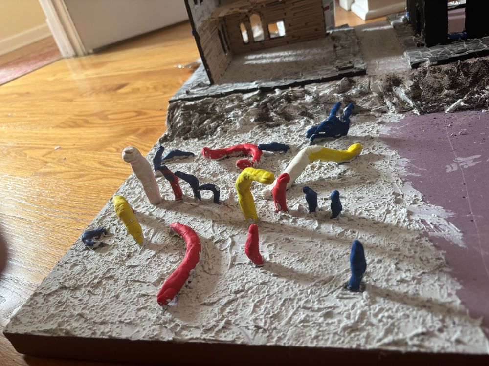 clay fingers sticking out of a foam board, coated with crusty goop