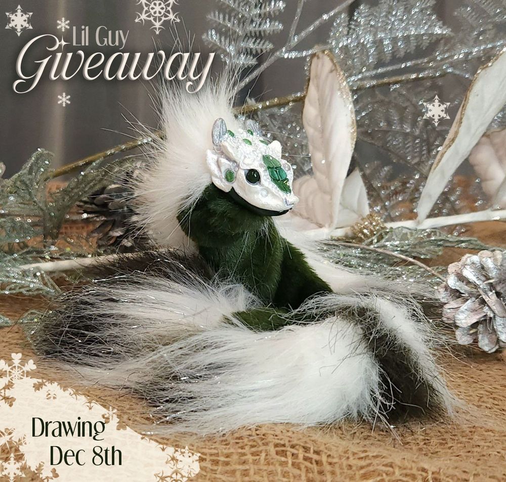 A lil wyrmy dragon art doll lays curled up, looking to the right. Their face is cheeky, white with silver horns and pine-green scales. Their body is ivory, with silver sparkle and evergreen stripes.
