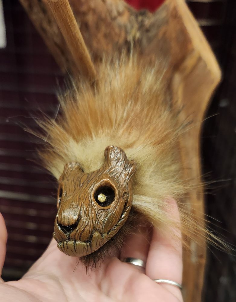 The face of a small art doll that looks like if a bulldog was crossed with a stump.