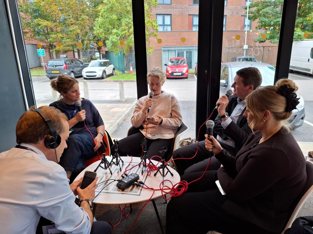 A group of people recording a podcast