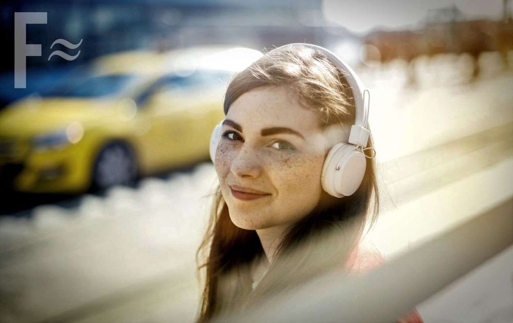 Young woman wearing headphone, Fresh On The Net logo in corner of pic