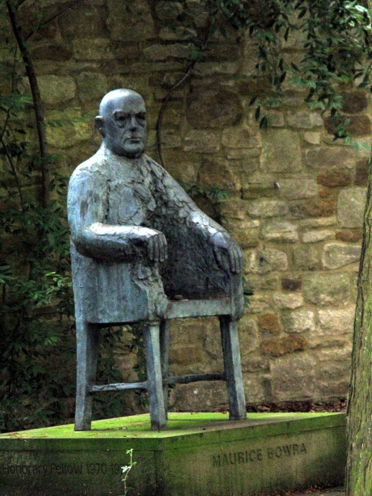Sculpture of a bald bloke merged with a chair. The top half is a bust and arms in a relaxed pose, the bottom is a chair, as if his legs and lower torso have been gouged out. It's labelled Maurice Bowra. Courtesy of a travel blogger called Caroline.