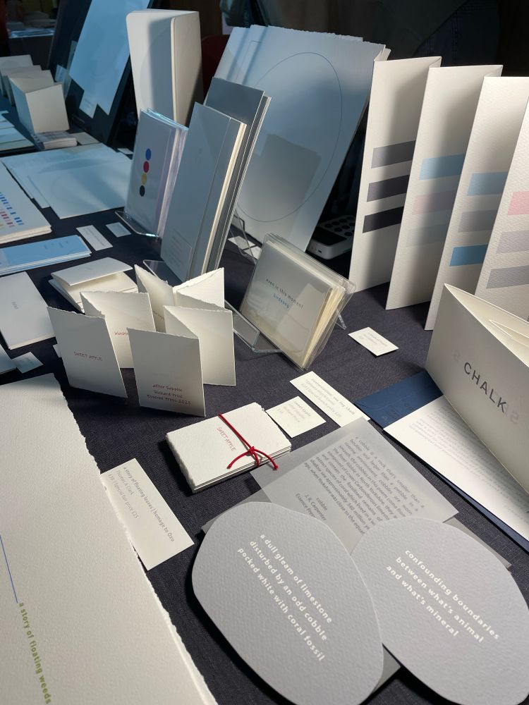 cobble, a new micro publication with Essence Press — a poem printed in light grey on two pieces of darker grey paper cut in the shape of cobbles of stone 