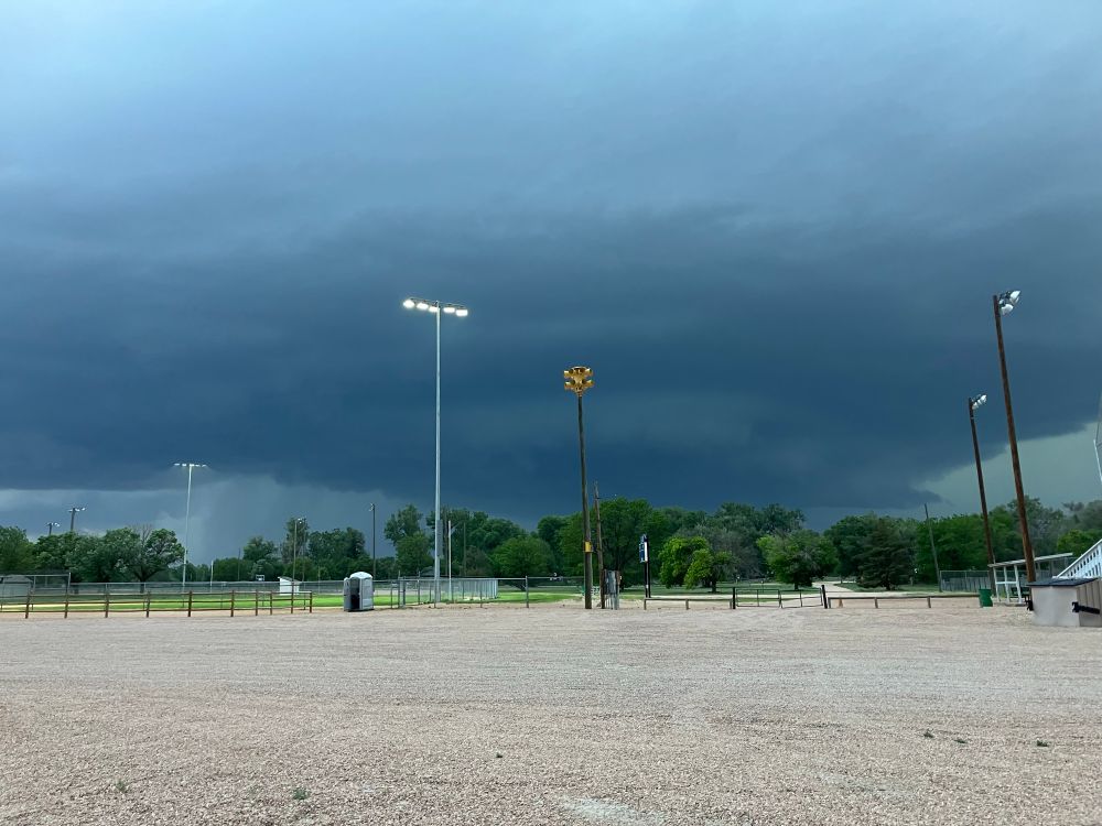 Ominous dark mothership cloud in the background with a Sentry tornado siren on a wooden pole in the foreground