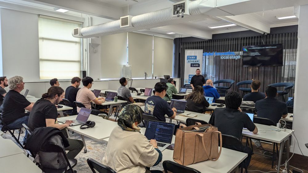A photo of Roman Gurevitch's Go concurrency workshop. Participants are sitting at desks, classroom style