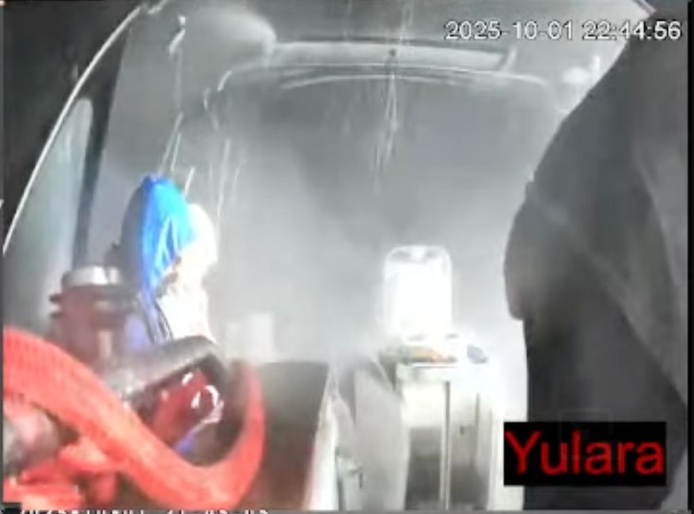 grainy footage of people aboard the Yulara being sprayed with water and light shone into their faces. 