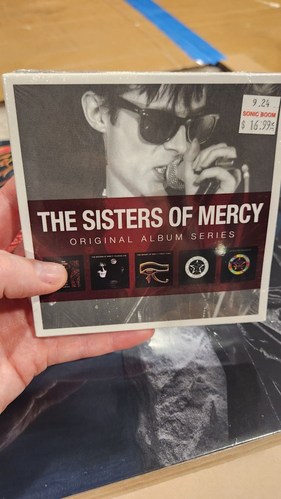 Dan holding The Sisters of Mercy: original albums series on CD