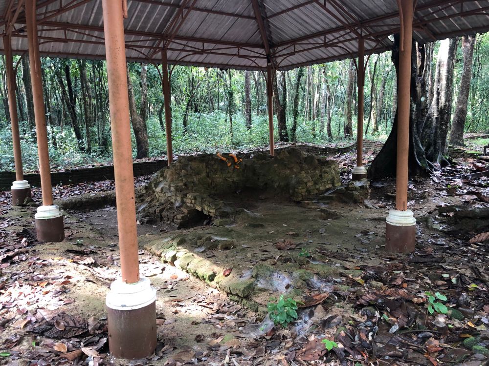 Ancient ruins of Tumpang Archeoloical Site, there is a roof covered them from above.