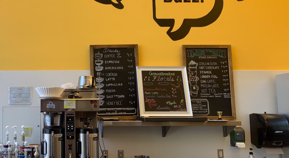 A close up of the drink menu, with art depicting different drinks and floral seasonal drinks.