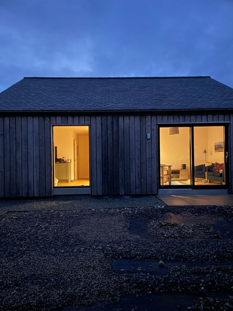 Small house lit up when the rain and wind is pounding outside