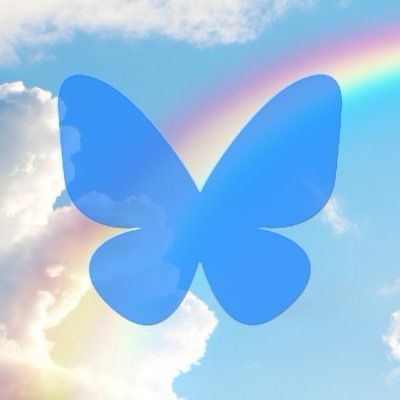 BlueSky logo with clouds and a lovely rainbow in the background