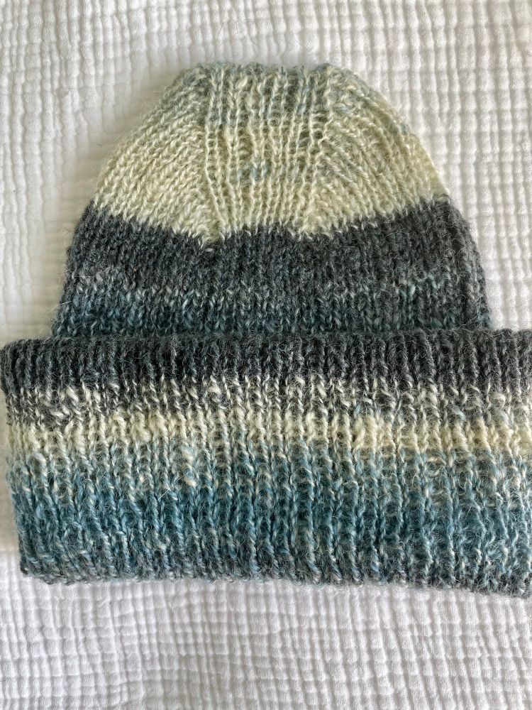 1x1 rib knit hat made from indigo dyed hand spun yarn in a striped pattern