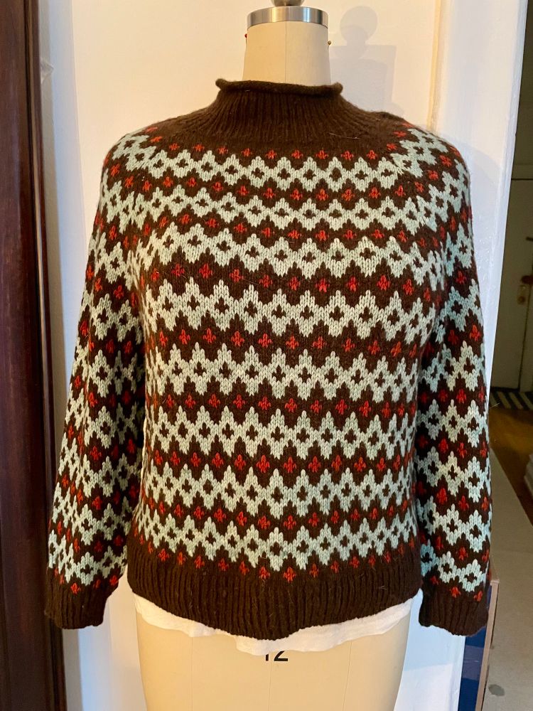 Color work sweater in a deep brown with shades of blue and red color work. Pattern is Inge sweater solo by Lene Holme Samsoe